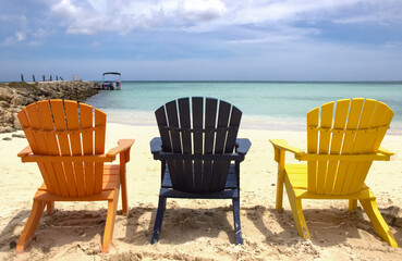 Three colorful beach chairs