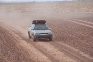 Fototapeta na wymiar SUV in the desert with a great off-road preparation