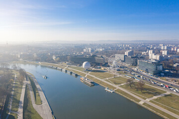 Obraz premium attractions at the Visla river in Krakow Poland. ballon and Ferris wheel. from Panorama in the morning mist. Aerial drone view from above. Sprink morning for under the city