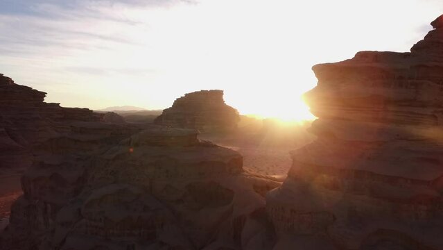 The sun's rays appear from behind the mountain neom