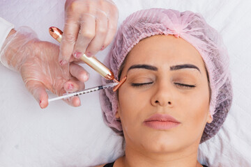 Botox application on patient, wrinkle prevention, rejuvenation, skin care, treatment.