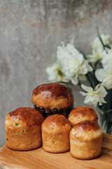 Delicious Easter cakes on a wooden table with flowers in the background. place for text. selective focus
