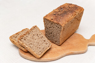 sliced rye bread on a wooden board on a white background	
