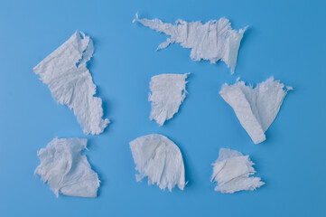 Torn tissue papers isolated on a blue background