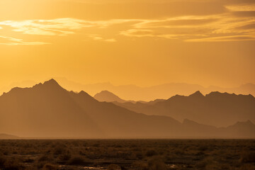Rugged reliefs of the mountains in the Iranian desert at sunset