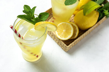 Fresh Lemonade or mojito cocktail with lemon, mint and ice