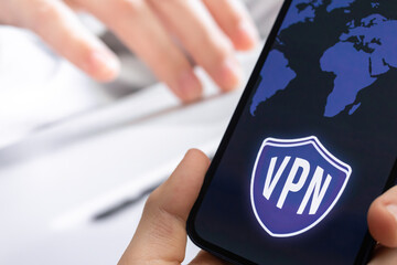 Person uses VPN technology on mobile phone. Anonymous and secure internet access concept background photo