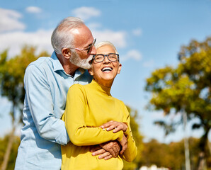 woman man outdoor senior couple happy lifestyle retirement together smiling love hug nature mature