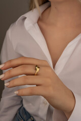 Obraz na płótnie Canvas Close-up of an elegant engagement diamond ring on beautiful woman's finger. love and wedding concept. Like the split tone Instragram process.