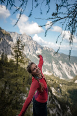 Happy young woman is enjoying her hike on a sunny September hike in Julian Alps.
