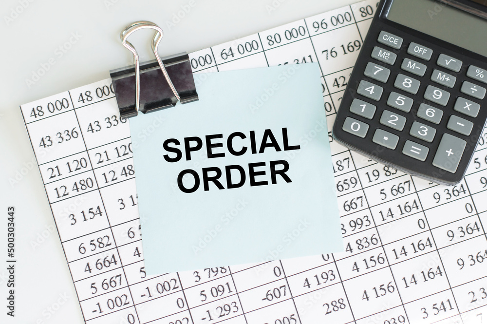 Poster special order text on a blue card clip to the paper with reports next to the calculator on the table