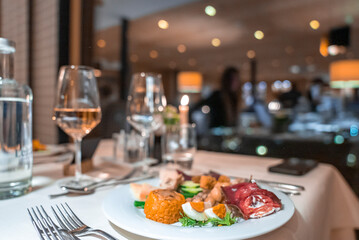 Close-up of boiled egg with meat and vegetable served in plate. Delicious food displayed on dining table. Yummy dinner at restaurant in luxurious holiday home.