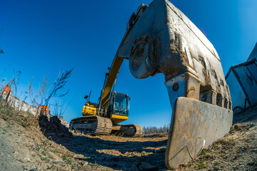 Not working yellow excavator. wide angle