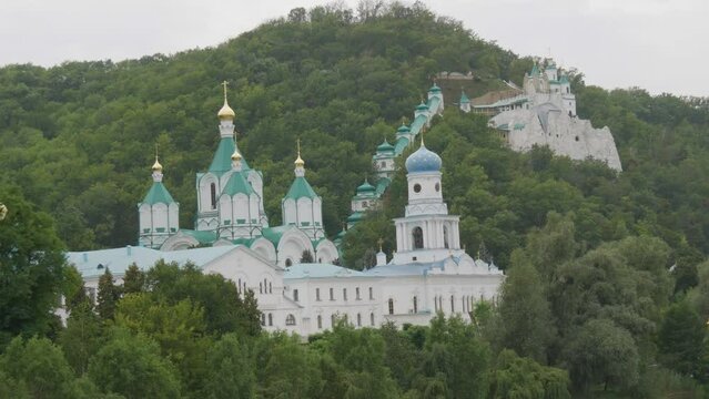 Svyatogorsk Lavra, Donetsk region, Ukraine. A beautiful old monastery is located in the valley of the Seversky Donets River on a mountain around the green foliage of trees