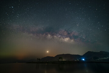 Fototapeta na wymiar Astro photography and Nightscape photography, Milky way over the boats at Mandan lake, Rajpipla, Gujarat