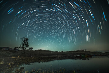Circular star trails over the lake. Astro photography and Nightscape photography at Mandan Lake,...