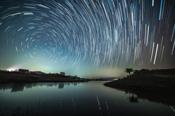 Circular star trails over the lake. Astro photography and Nightscape photography at Mandan Lake,...