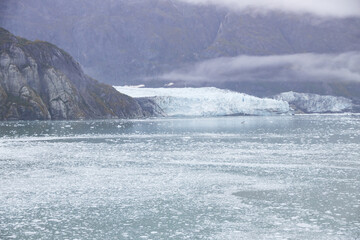 Ice chunks in the water and glacier in background at Glacier Bay, Alaska, USA
