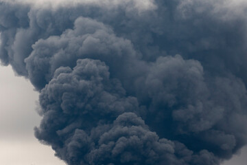 Thick black smoke covers the sky during the war between Ukraine and Russia