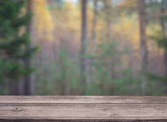 Empty wooden table with bokeh forest view for catering or food, product showcase mockup template
