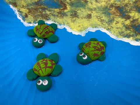 Three handmade turtles made from recycled materials