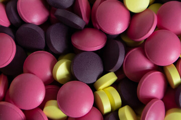A lot of colorful round-shaped tablets close-up.