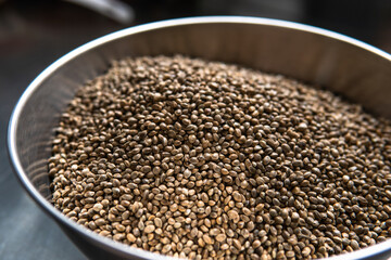 fresh marijuana seeds on a dark background. Medicinal cannabis seeds for diet.