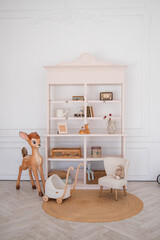 Stylish scandinavian newborn baby room with toys, children's chair. Modern interior with grey background walls © vladdeep