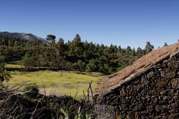 Typical Canarian rural house of the island of La Palma with the Cumbre Vieja volcan in the distant...