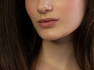 Obraz premium Perfect natural lip makeup. Close up macro photo with beautiful female mouth. Plump full lips. Close-up face detail. Perfect clean skin, light fresh lip make-up. Beautiful spa tender lip