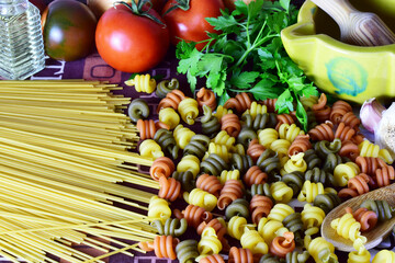 Variety of pasta, spaghetti and colored spirals.