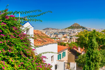 Old city Plaka Athens view with mount Lycabettus and pink Bougainvillea flowers