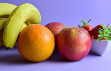 Fototapeta na wymiar fruits on a mauve background
