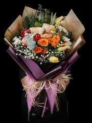 Young woman with a gift bouquet of fine peach roses, mono bouquet of roses. Peony roses flowers....