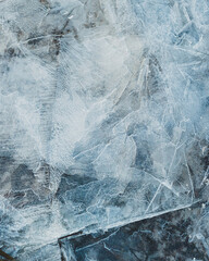 cracked ice close up, deep frozen lake blue ice texture, repeating pattern