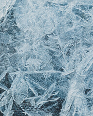 cracked ice close up, deep frozen lake blue ice texture, repeating pattern