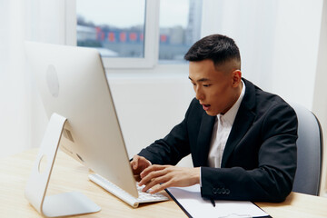 businessmen sitting at a desk in front of a computer Lifestyle