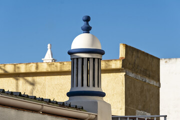Fototapeta premium traditional openwork chimney on a roof in Fuseta, Algarve, Portugal..