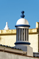 traditional openwork chimney on a roof in Fuseta, Algarve, Portugal.. - obrazy, fototapety, plakaty
