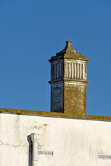 Obraz premium traditional openwork chimney on a roof in Fuseta, Algarve, Portugal..