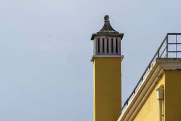 traditional openwork chimney on a roof in Fuseta, Algarve, Portugal..