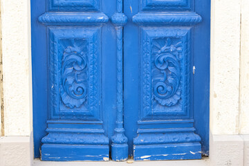 ultramarine blue door and engraved panels in Fuseta, Algarve, Portugal