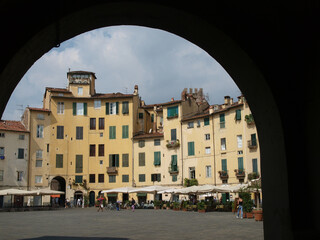 The Piazza Anfiteatro - Lucca , Italy. View from piazza Anfiteatro, former a Roman Ampitheatre, in Lucca. Tuscany, Italy. - obrazy, fototapety, plakaty