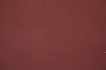 Old maroon concrete painted wall background