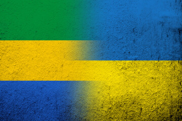 National flag of Gabon with National flag of Ukraine. Grunge background