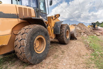 Rubber wheel loader yellow excavator. Heavy-duty machine for earth and road repairs.  