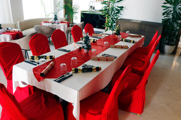 christmas concept festive dining table and chair set up with red and white cloths
