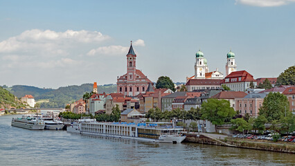 River cruise ships are moored at Passau, Germany on  the Danube River on a bright summer day.