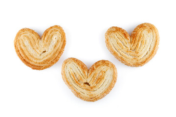 Palmier cookies or puff pastry ears isolated on white background. Cookies in the shape of a heart, top view. Close-up.
