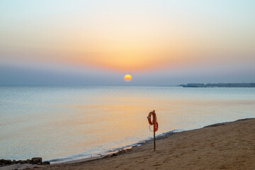 Obraz premium Landscape of sunrise, sun, sky and beach on the shores of the Red Sea in Hurghada, Egypt